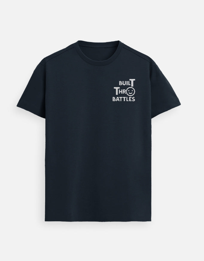 “Built Thro Battles Unisex FeatherLite T-Shirt in Navy Blue – Supima Christian tee highlighting strength through faith, made & packed in India by StyleYourFaith.”